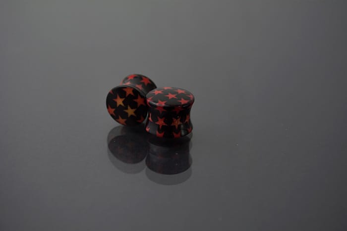 Dilatador acrílico negro estrellas rojas