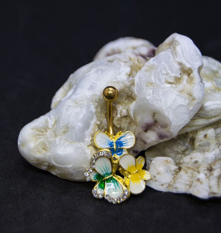 Navel acero dorado mariposas color