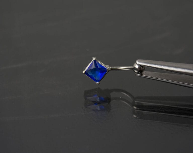 Navel acero joya azul