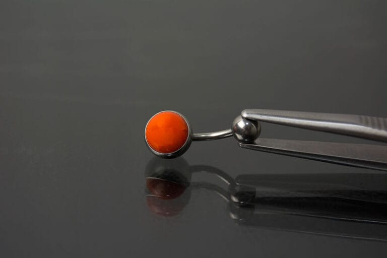 Navel acero joya color naranja